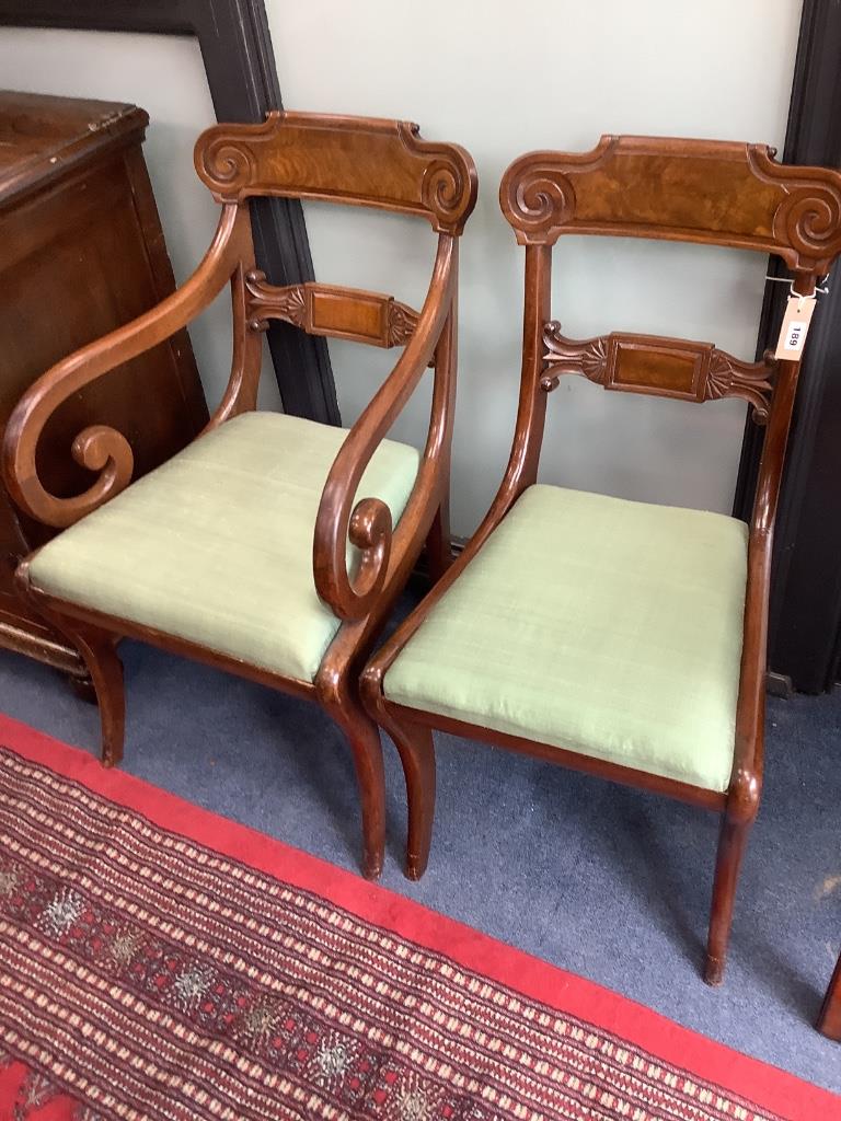 A set of six George V mahogany sabre leg dining chairs (two with arms)